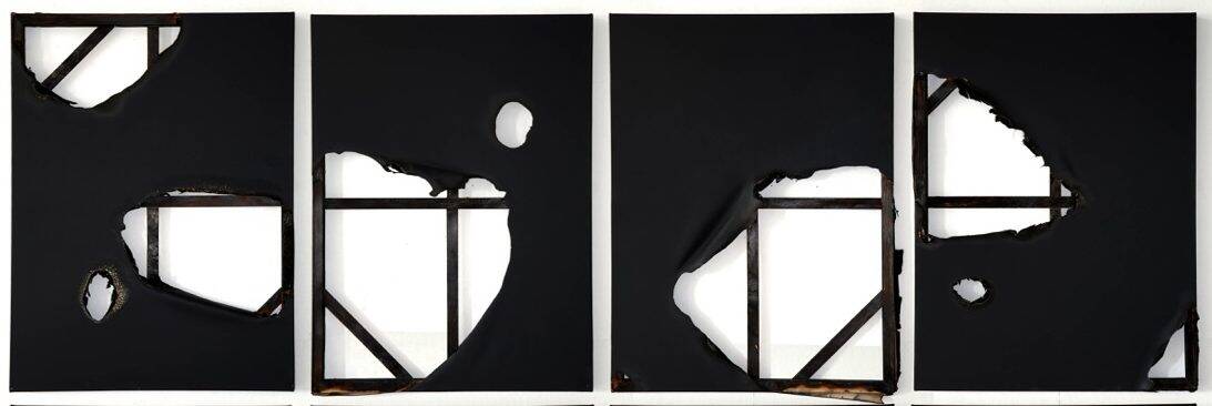 Four black and white paintings with torn canvas and exposed stretchers.