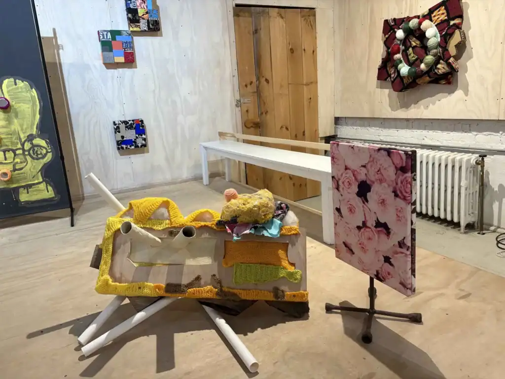 Vivid textile sculptures and mixed media art displayed in an art gallery setting.