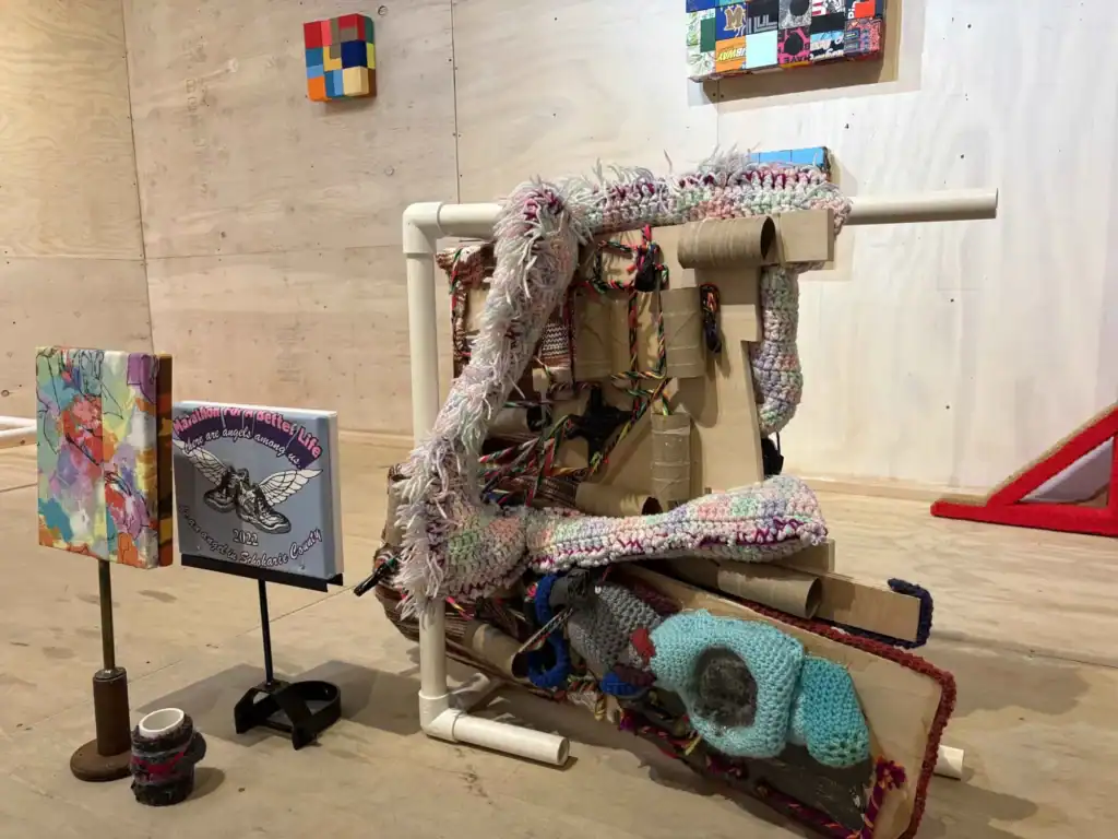 An interactive art piece featuring textiles, mixed media, and sculptural elements at Time & Space Li.