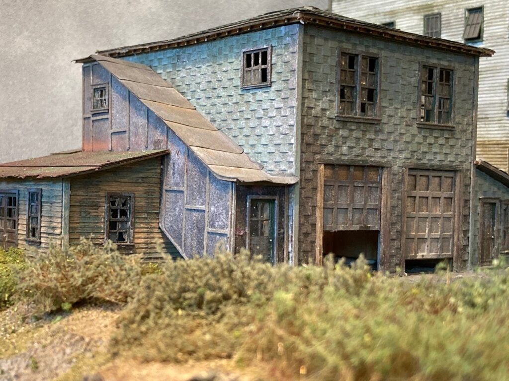 Dennis Gordon sculpture: weathered wooden house with attached garage